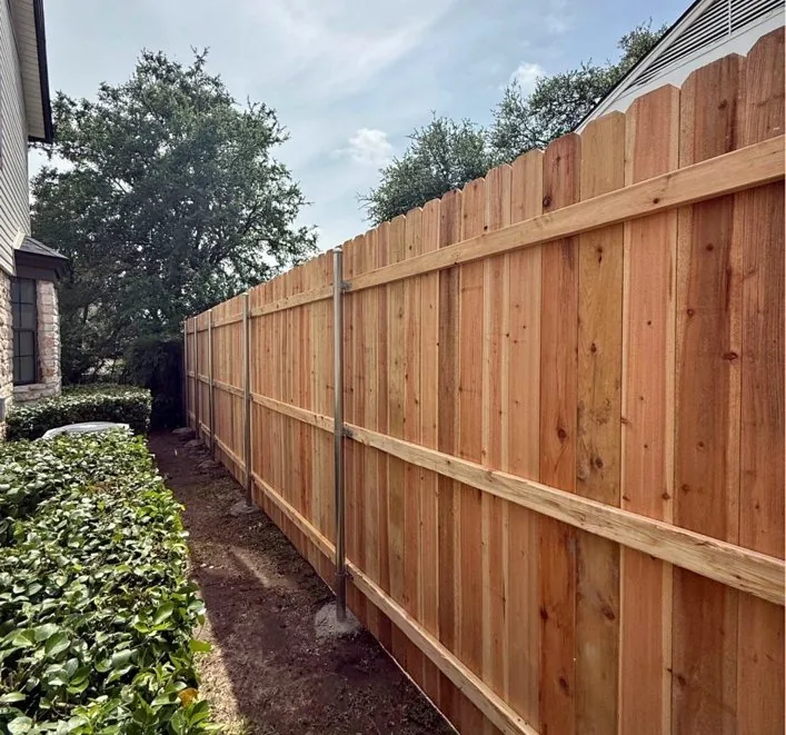 Cedar privacy fence alongside a house